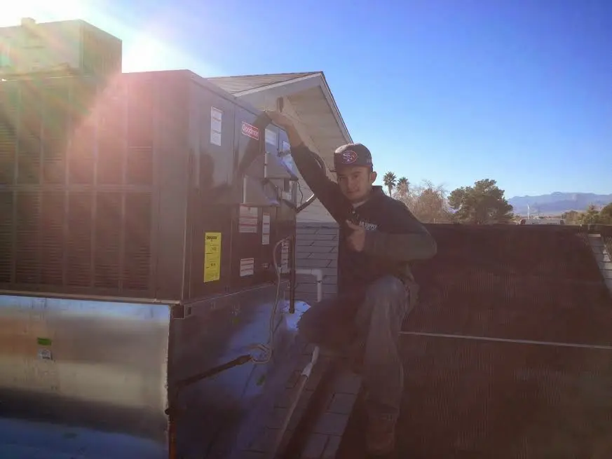 HVAC technician performing Air Duct Cleaning on a rooftop unit in Upper Arlington